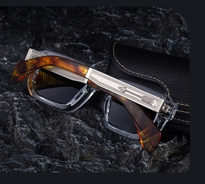 Detailed silver-engraved temples and amber tips on luxury square frame sunglasses