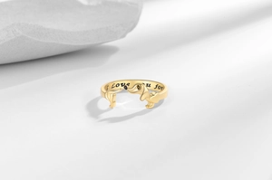 Close-up of golden dachshund ring with I Love u for engraving on the inner band