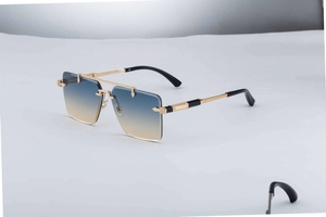 Close-up of rimless gold sunglasses with gradient lenses and textured metal detail