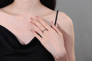 Detail of silver adjustable ring featuring a gold Ichthys fish charm with Jesus engraving