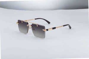 Macro detail of rimless square sunglasses with gold diamond-engraved metal temples