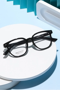 Macro view of black square frame eyeglasses with metallic detail and professional specs