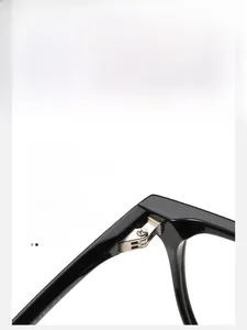Macro shot of durable silver-tone metal hinges on square-frame black acetate glasses