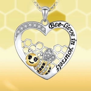 Heart-shaped bee necklace with honeycomb design and 'Bee-lieve in yourself' engraving