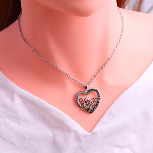 Detail of bee necklace with Bee-lieve in yourself engraving and honeycomb heart pendant