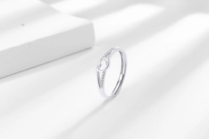 Close-up of silver heart-shaped ring featuring sparkling white cubic zirconia insets