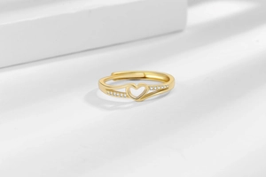 Detail of gold-plated heart ring with sparkling zircons and adjustable open band