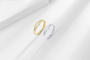 Detail of adjustable heart rings in gold and silver finish with pavé cubic zirconia