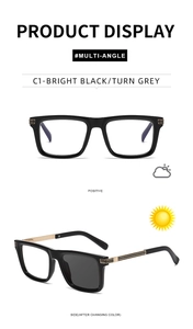 Detail of square black sunglasses showing photochromic lenses and gold temple stripes