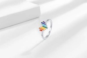 Detail of adjustable silver ring with colorful rainbow geometric bars and polished finish
