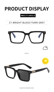 Detail view of square frame glasses with metal trim and photochromic lenses