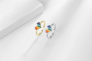 Detail of adjustable open rainbow enamel rings in gold and silver finish with colorful inlay