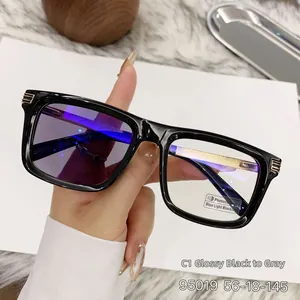 Detail of square photochromic sunglasses with black frame and golden metal temples