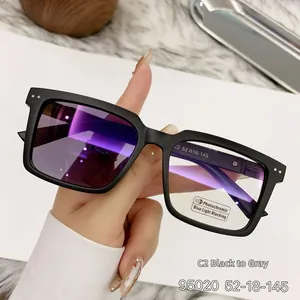 Close-up of matte sand black photochromic square glasses with blue light blocking lenses