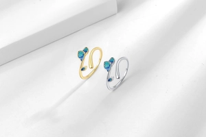 Detail of vine leaf rings with green enamel inlay in gold and silver finish