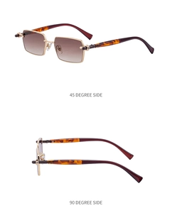 Detail view of rectangular sunglasses with gold metal frame and amber tortoise temples
