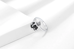 Macro detail of cute panda ring showing black enamel finish and bamboo leaf design