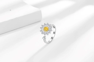 Detail of sunflower spinner ring with yellow smiley face center and zircon petals