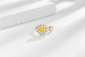 Macro detail of rotating sunflower ring with yellow enamel face and cubic zirconia petals