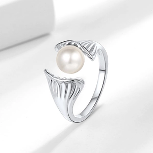 Elegant adjustable silver ring with pearl set in a seashell design on white block