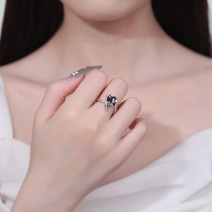 Minimalist silver open ring featuring a cute panda and leaf design on model hand