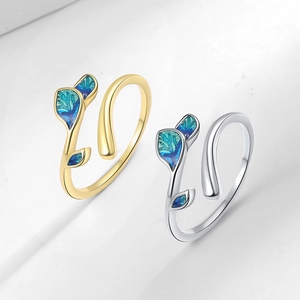 Elegant leaf-shaped open ring set in gold and silver with blue-green enamel leaves