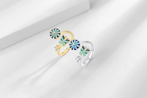 Detailed close-up of rotating enamel butterfly rings in gold and silver finish