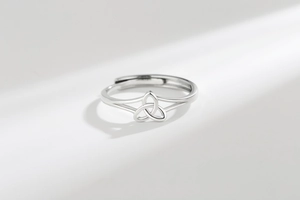 Macro shot of silver Triquetra Celtic knot on adjustable open ring for women