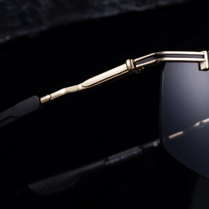 Macro shot of golden metal temple detail and hinge on sports cycling sunglasses