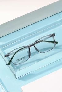 Close-up of translucent grey square frames with striped temples and size details