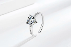 Macro detail of silver ring featuring heart-cut pink zircon and pavé setting
