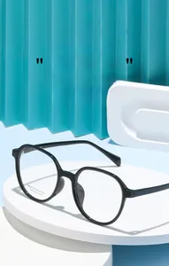 Detail view of black square oversized optical frames on a clean geometric pedestal