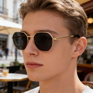 Men's square frame sunglasses with gold metal temples shown on model in outdoor setting