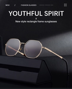 Detailed close-up of polygon metal sunglasses with dark lenses on a black gift case