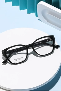 Detail of stylish black cat-eye glasses frame with model specs on a modern display