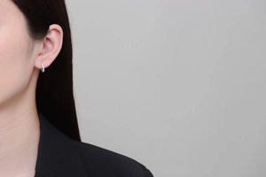 Silver thin hoop earring on model showing sleek minimalist style and polished metal finish