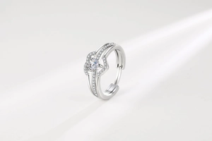 Detailed view of heart-shaped silver ring with sparkling zircon inlays and adjustable band