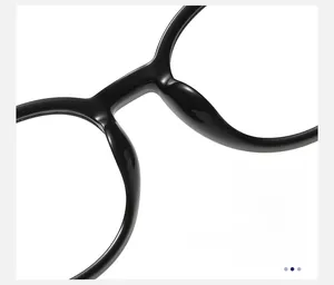 Detail of ergonomic nose pads on lightweight black round eyeglass frames for comfort