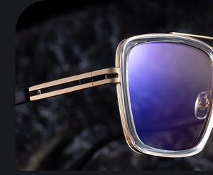 Close-up of golden metal double-beam frame and purple reflective lens on square sunglasses