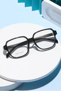 Detail of black square optical glasses frame showing the sleek temple and temple markings