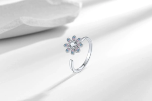 Macro view of adjustable silver daisy ring featuring sparkling colorful zircon petals