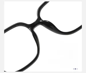 Detail of glossy black square glasses frame featuring comfortable integrated nose pads