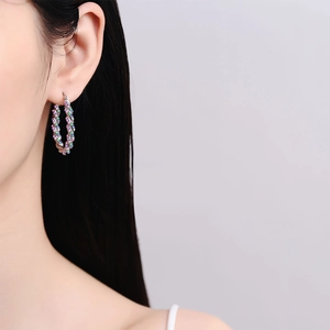 Fashionable U-shaped twisted hoop earrings with multicolored zircon stones on model