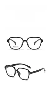 Close-up of stylish large square glasses frame in bright black with metal rivet details