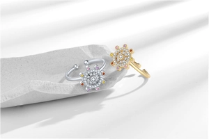 Detailed macro of rotatable sun flower rings with colorful zircons on stone base