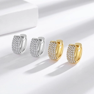 Polished gold and silver huggie earrings with micro-pave cubic zirconia stones
