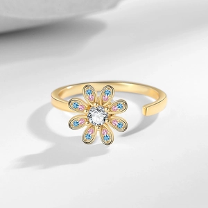 Rotating daisy flower open ring in gold with pink and blue gemstones and zircon center