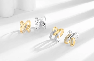 Detail of interlocking X-shaped rings with sparkling micro-pave crystals in gold and silver