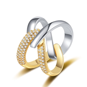 Detail of interlocking gold and silver rings with pave set zircon stones on white background