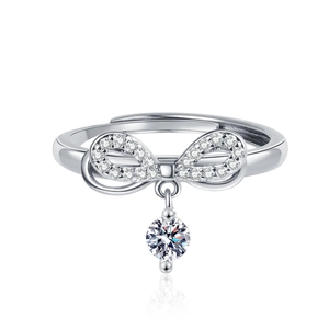Elegant adjustable silver bow ring with sparkling pavé zircons and a round pendant charm